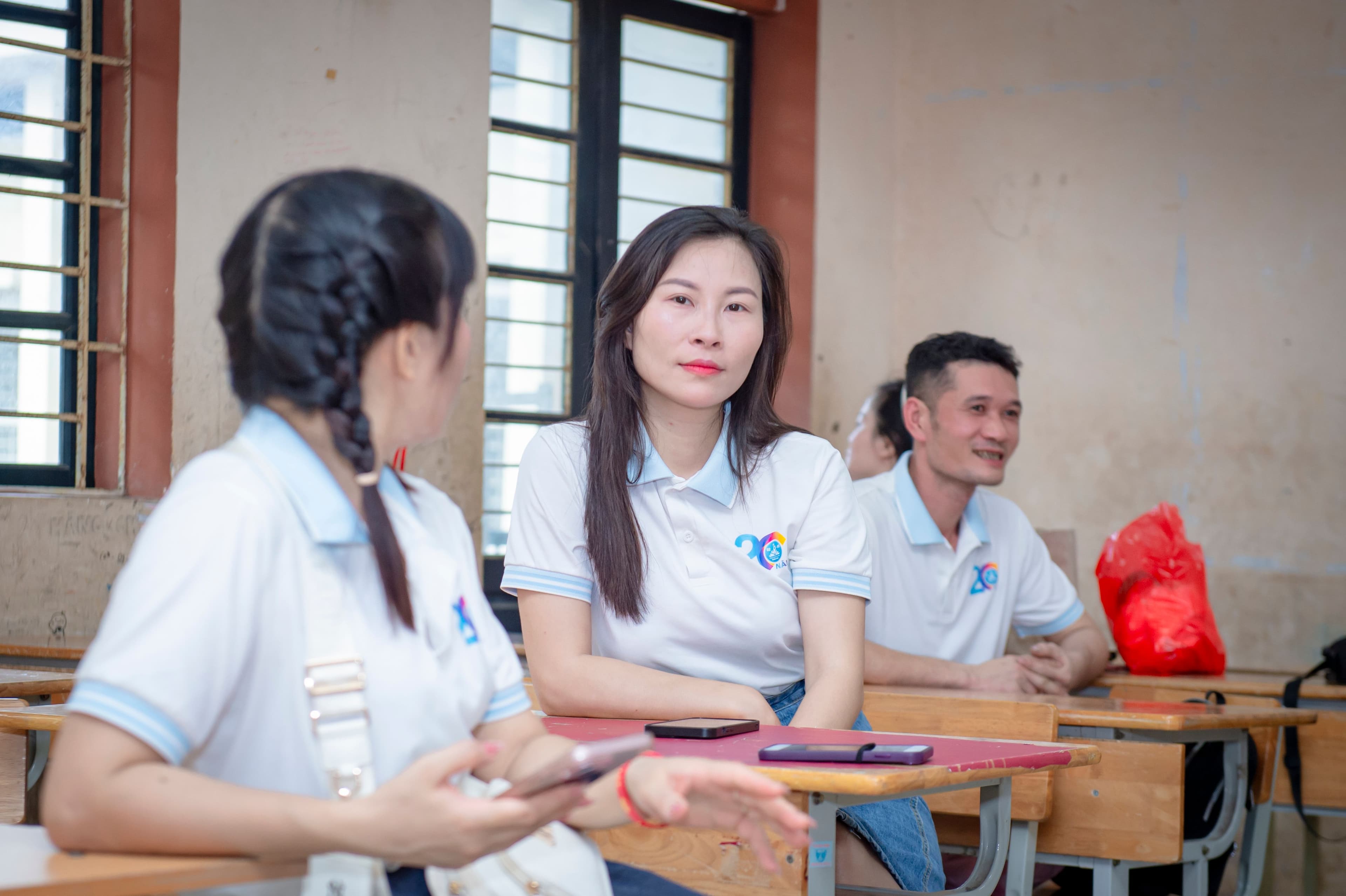 Students in a classroom discussing academic course choices.